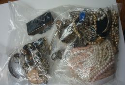 Two bags of an assortment of silver objects, necklaces, beads and costume jewellery