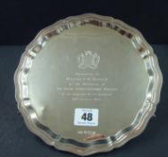 Silver `Chippendale` bordered salver mounted on three ribbed scroll feet, engraved with Royal