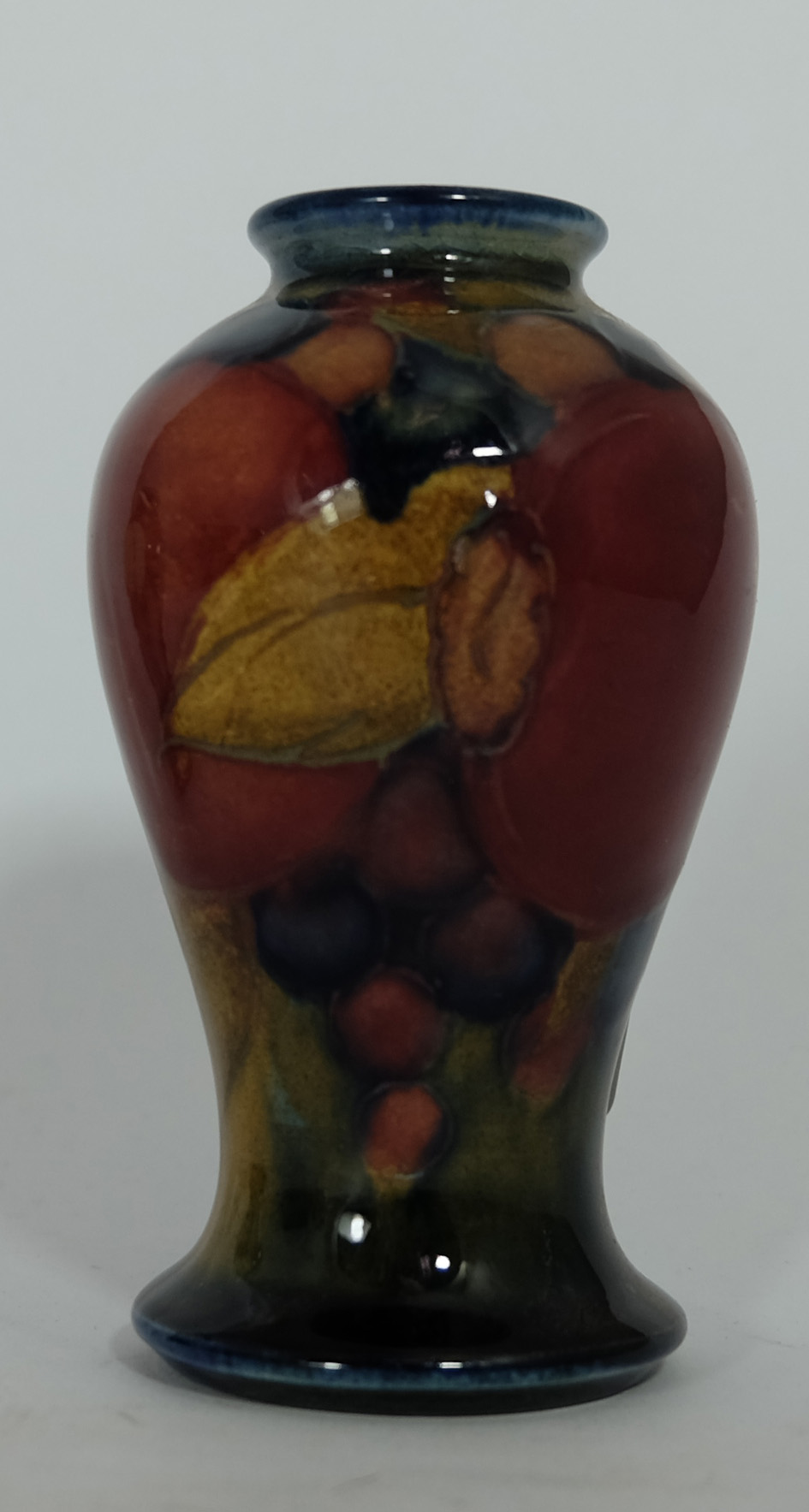 Moorcroft small vase decorated in the Pomegranate design, height 9.75cm