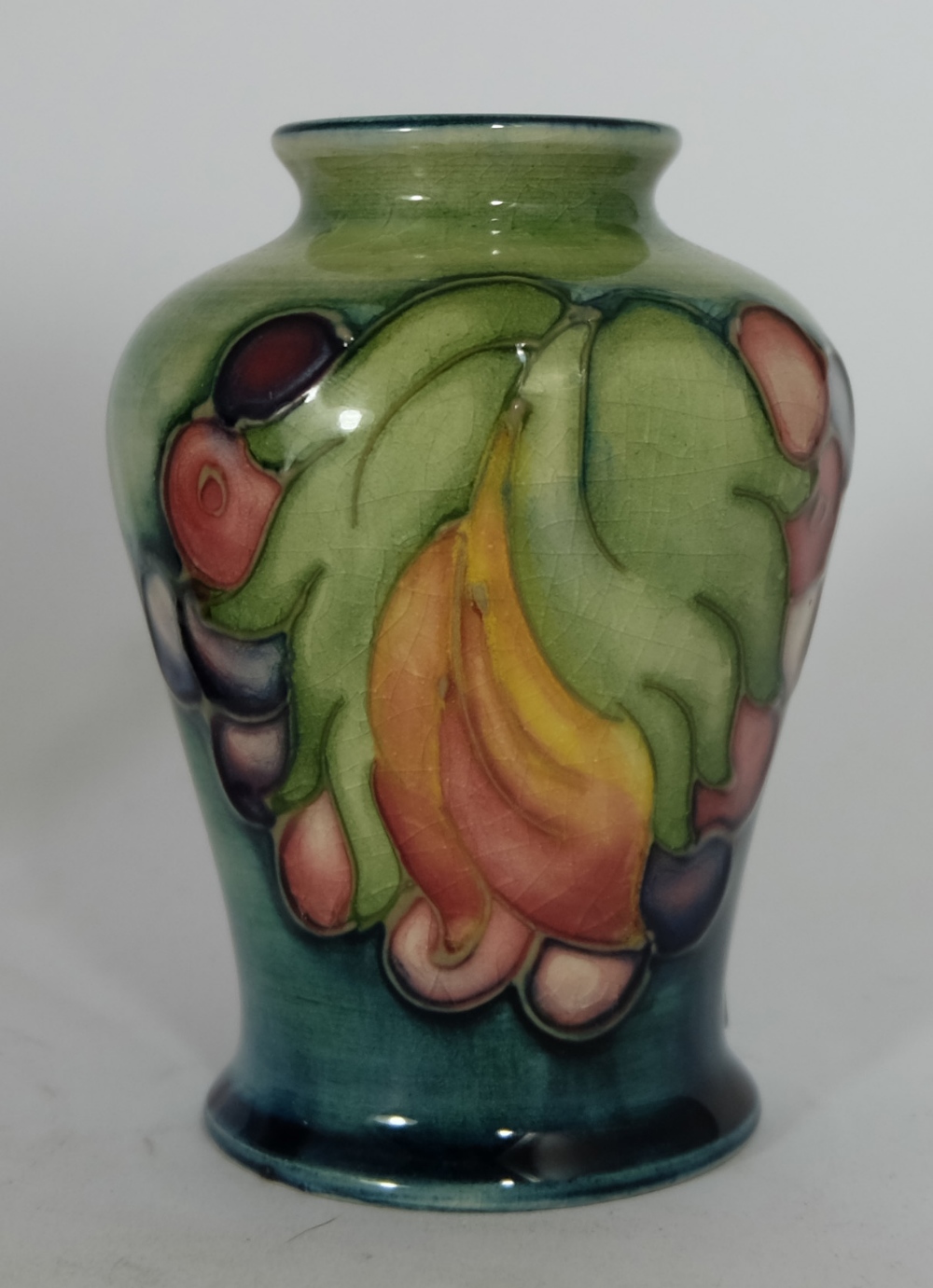 Moorcroft small vase decorated in the Leaf  design, height 9cm