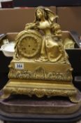 19th century french gilt metal clock of a lady in 18th century costume, on oval base lacking glass