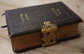 A Leatherbound Hardback Bible labeled Daily Services Oxford Mdrrrxlix with an engraved detail around