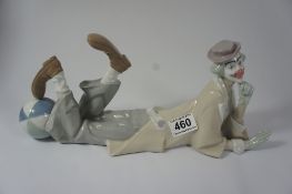 A Lladro figure of a clown with ball lying down length 39cm (in original box)