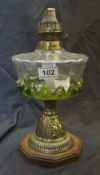 Edwardian brass and coloured glass lamp base with brass burner on wood plinth, height 32cm