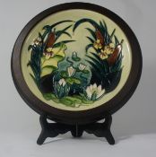 Moorcroft wall plaque decorated with lilies  and Bulrushes in original wood frame dated 1995,