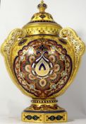 Royal Crown Derby three handled vase and cover richly decorated in red, blue and gold colours,
