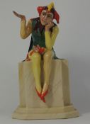 Carlton Ware figure of seated Jester on wall height 21cm
