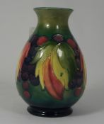 Moorcroft vase decorated in the leaf & berries design, height 16cm