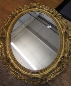 A Large Guilt oval wall mirror 91cm by 70cm