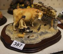 Border Fine Arts figure of Farmer milking Guernsey Cow in shipping, by Ray Ayres on wood base