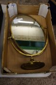 A large ornate brass free standing mirror