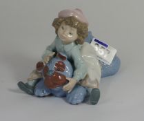 Lladro Figure of a girl resting on a large teddy bear