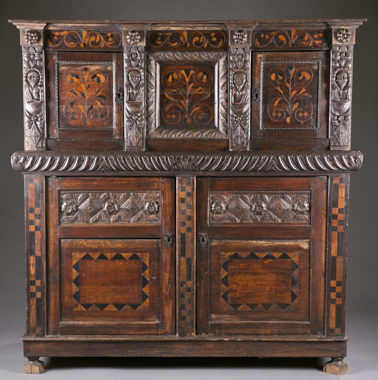 A Continental carved and inlaid cupboard. Late 17th / early 18th century. Having 2 top blind,