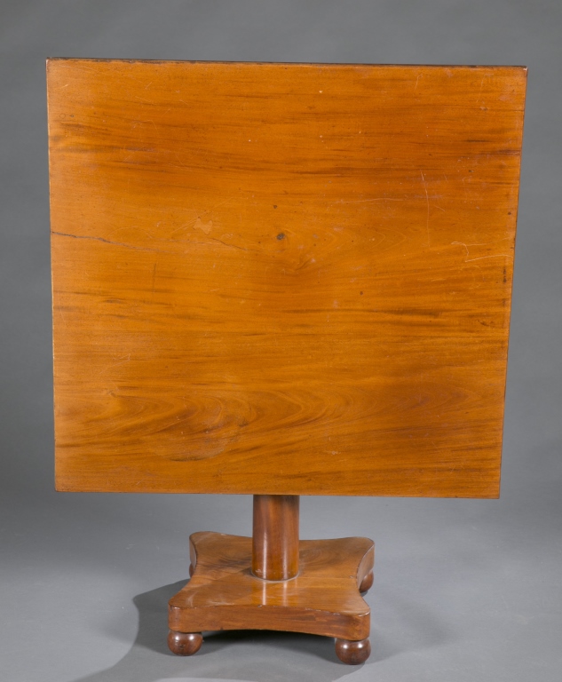 A hardwood tilt-top table. 19th century. With pedestal base and ball feet. (NEEDS MEASUREMENTS)