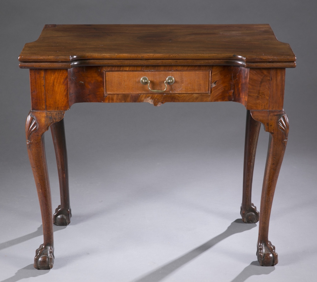 A flip top veneer and hardwood card table. Having cabriole legs with carved shell on knee, ball and