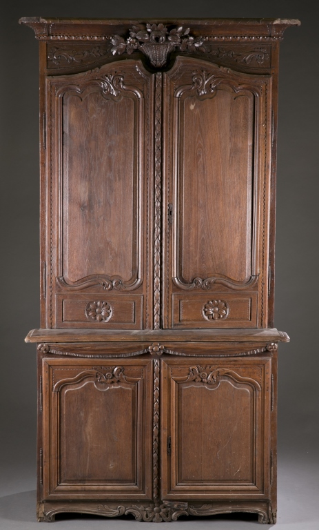 A French carved oak cabinet. Late 19th century. Upper case incorporating detailed floral carving