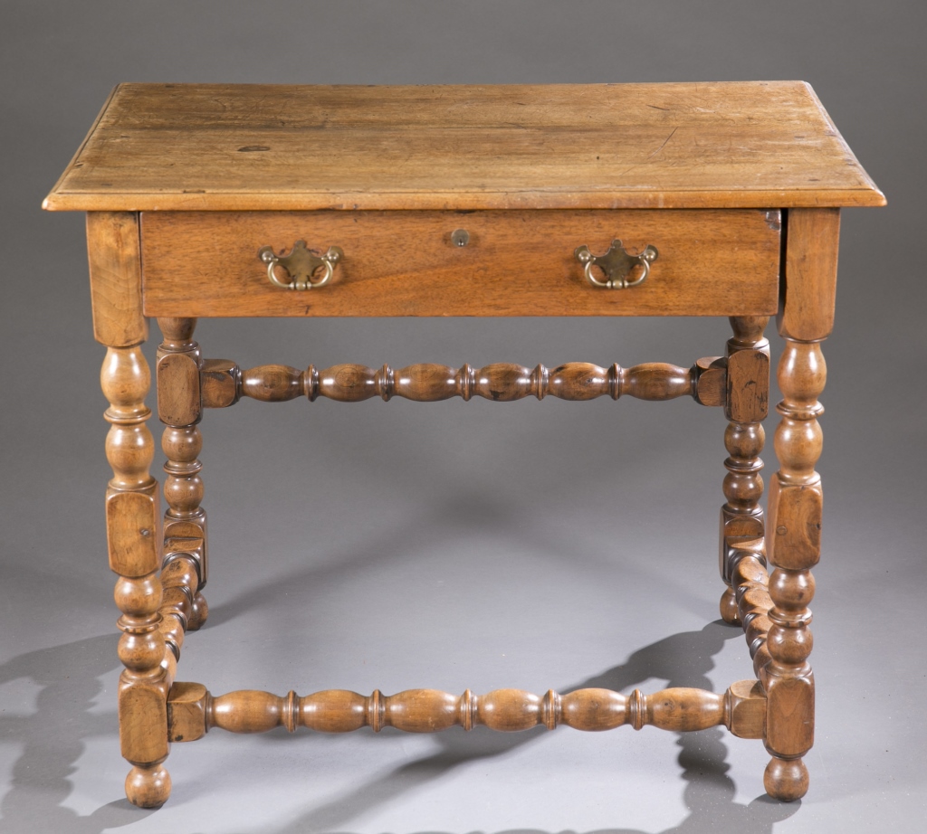 An English oak table.  18th century. Incorporating turned legs and box stretcher, singular drawer