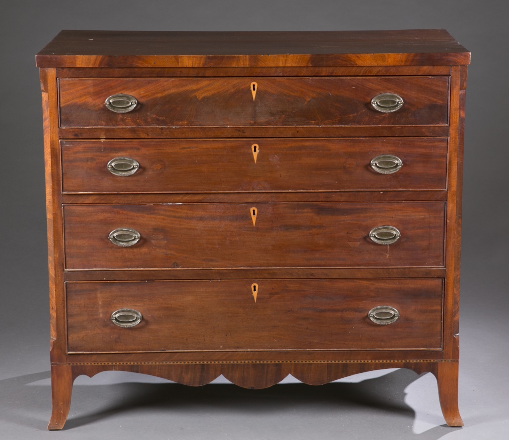 A Federal style mahogany 4 drawer chest. Mid 19th century. With inlaid escutcheons and replaced