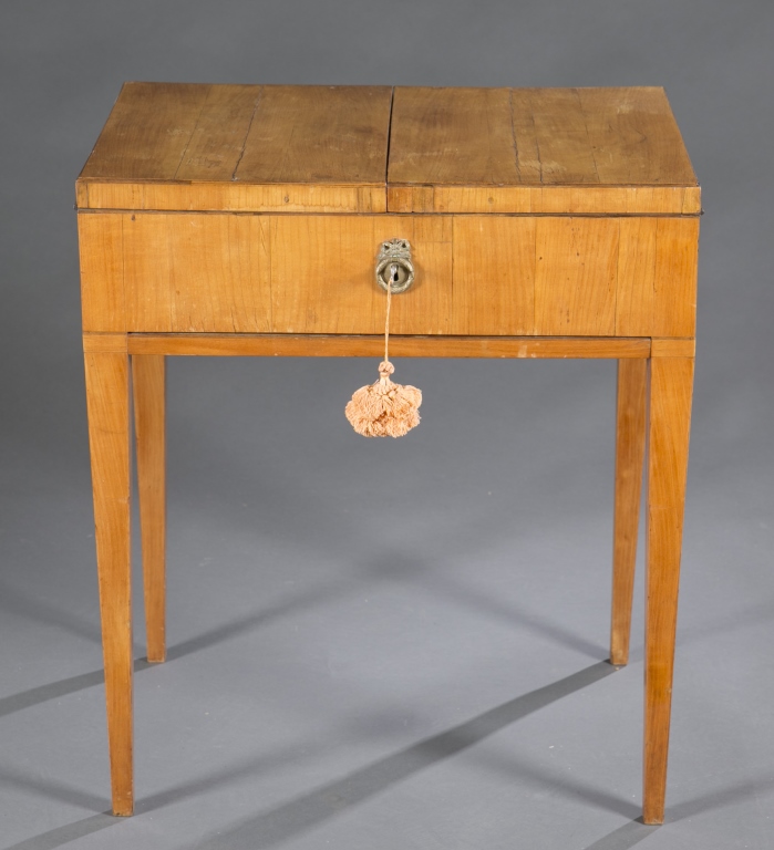 A Neoclassical style maple veneer  sewing table.  Late 19th century. Double lift top revealing 3