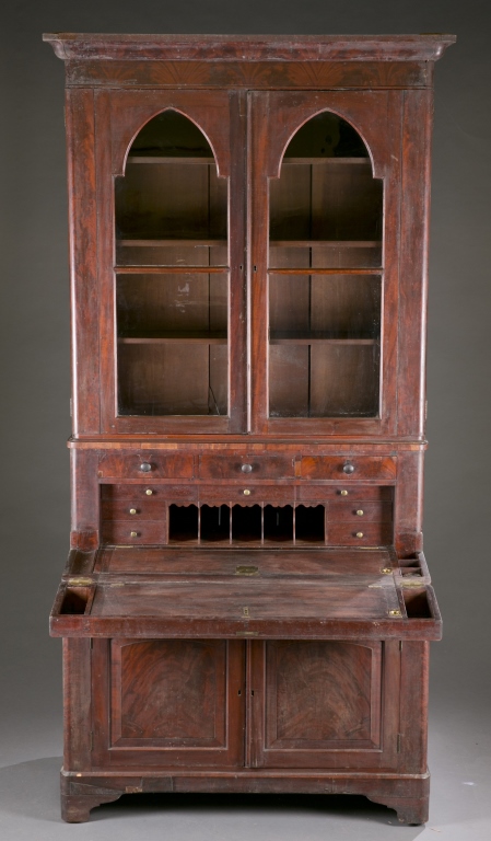 An American flame mahogany secretary by Lewis McKee & Co. c.1830s-40s.. Upper case has 2 glass