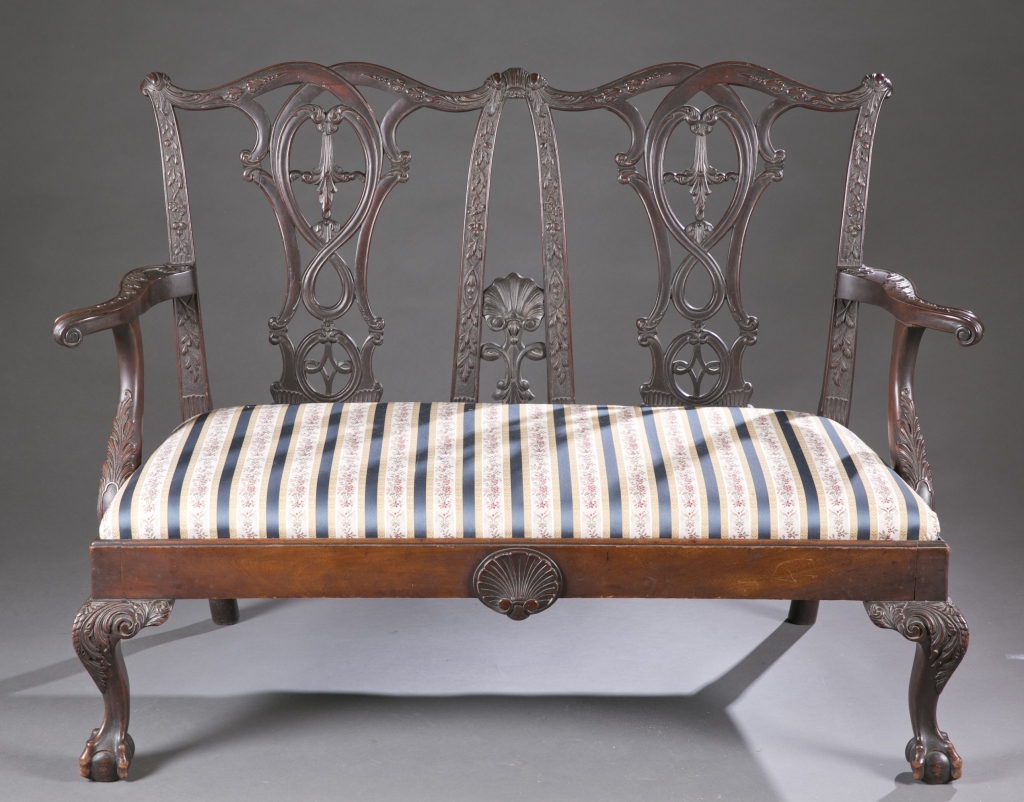 A Chippendale style revival settee.  Mid 19th c. Incorporating solid, carved hardwood with shells