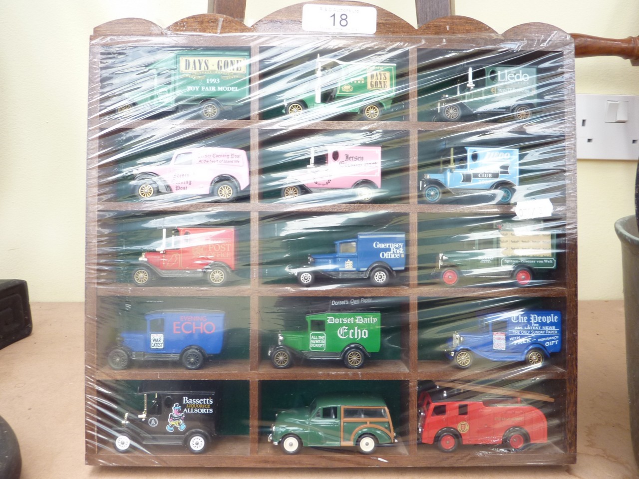 A selection of Lledo & Days Gone die-cast models in a display cabinet