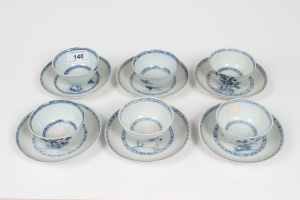 Six 18th century Chinese export blue and white Nanking Cargo tea bowls and saucers with painted tree