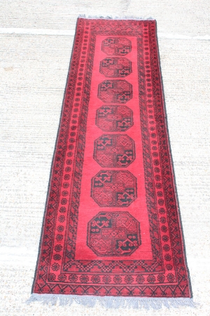 Persian runner with geometric decoration on red and blue ground, 297cm x 77cm