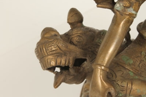 Eastern bronze figure group modelled as a stylised recumbent lion, a Goddess seated on its back, - Image 12 of 12