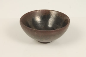 Small antique Chinese bowl of simple form, with speckled treacle glaze - underside bearing