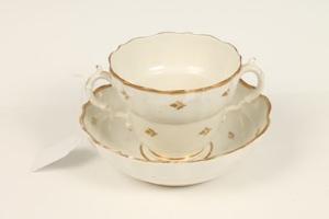 Rare eighteenth century Caughley chocolate two-handled cup and saucer, decorated with gilt sprigs,