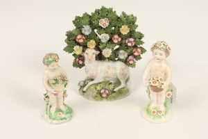 Eighteenth century Derby seasons figure of a putto holding a basket of flowers, 10cm, another