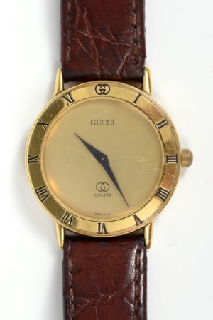 Gentlemen's Gucci wristwatch with quartz movement, circular gold coloured dial and Roman numerals to