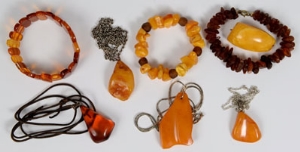 Four amber / amber-type pendants, similar brooch and three similar bracelets