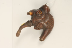 Late nineteenth century pipe, realistically carved as a bulls' head, with inset eyes, possibly Black