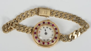 Ladies' 1920s gold (18ct) wristwatch with diamond and ruby bezel on gold (14ct) curb link bracelet