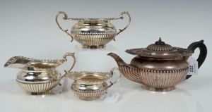 Edwardian silver four piece tea set comprising teapot of half-fluted form, with flared gadrooned,