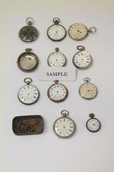 Box containing a selection of pocket watch movements and associated items, some with silver cases (