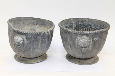 Pair of old lead planters of fluted form, with ropework borders and applied smiling face masks, 32cm