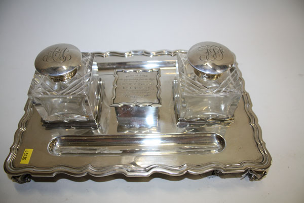 Edwardian silver desk stand of rectangular form with scroll border, on four leaf scroll feet, two