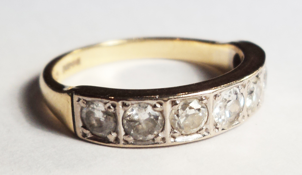 An 18ct. gold ring, set with half band of seven diamonds