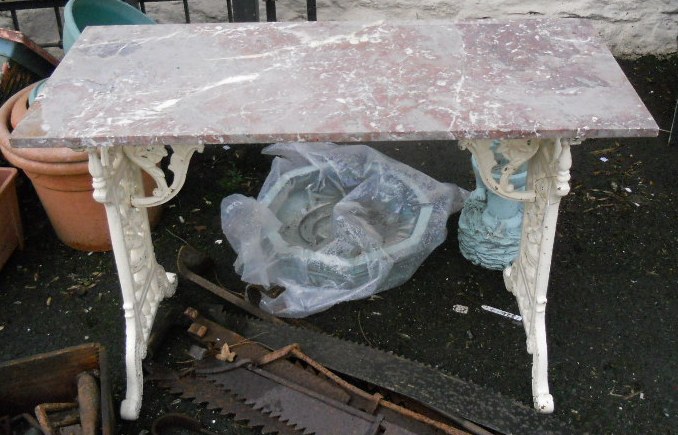 A cast iron and marble top conservatory table