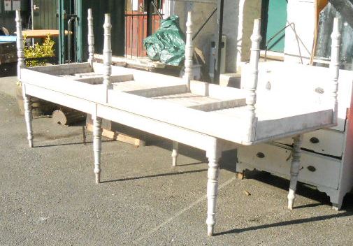 An 11’7” Edwardian painted pine slat top horticultural table set on turned legs - sold with a 10’