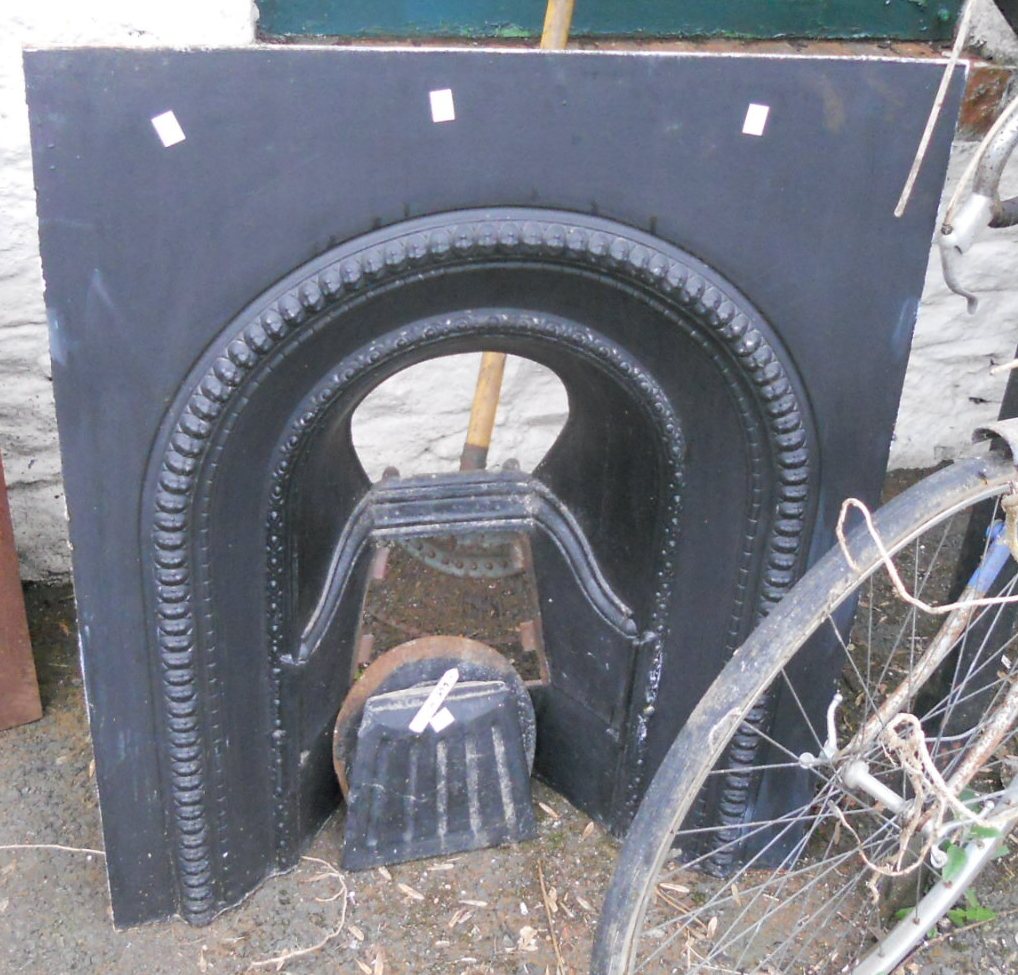 A Victorian cast iron fire place with decorative bosses - marked No 101 03 verso