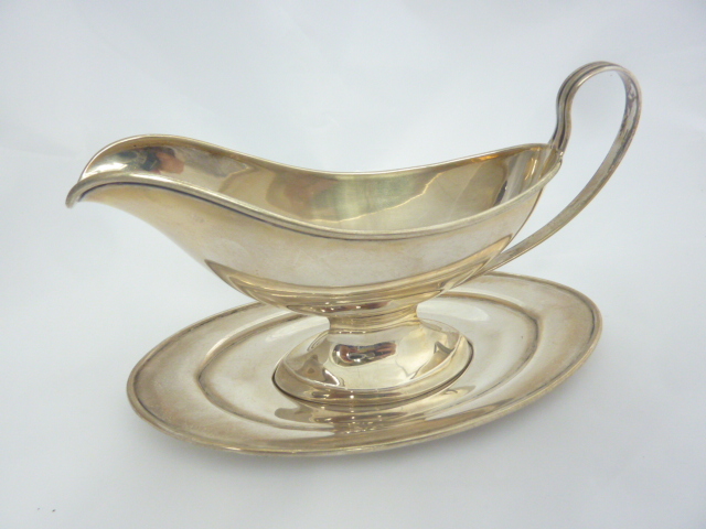 A STERLING SILVER SAUCE BOAT ON STAND