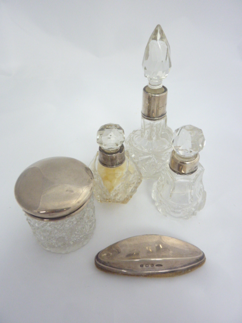 FOUR SILVER MOUNTED COSMETIC VESSELS, and a nail buffer (5)