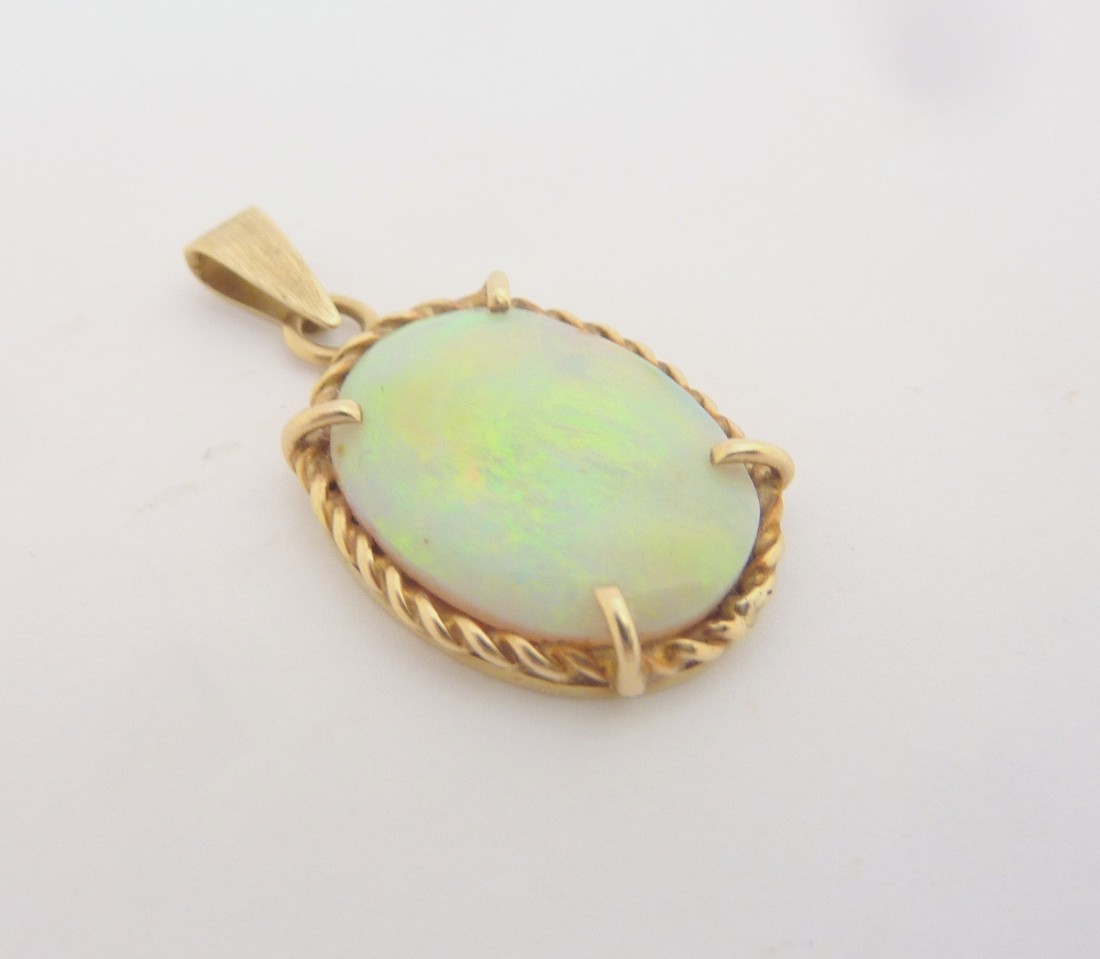 AN OPAL PENDANT, the oval shape opal with twisted mount to the plain tapered bail, diameter 1.8cm by