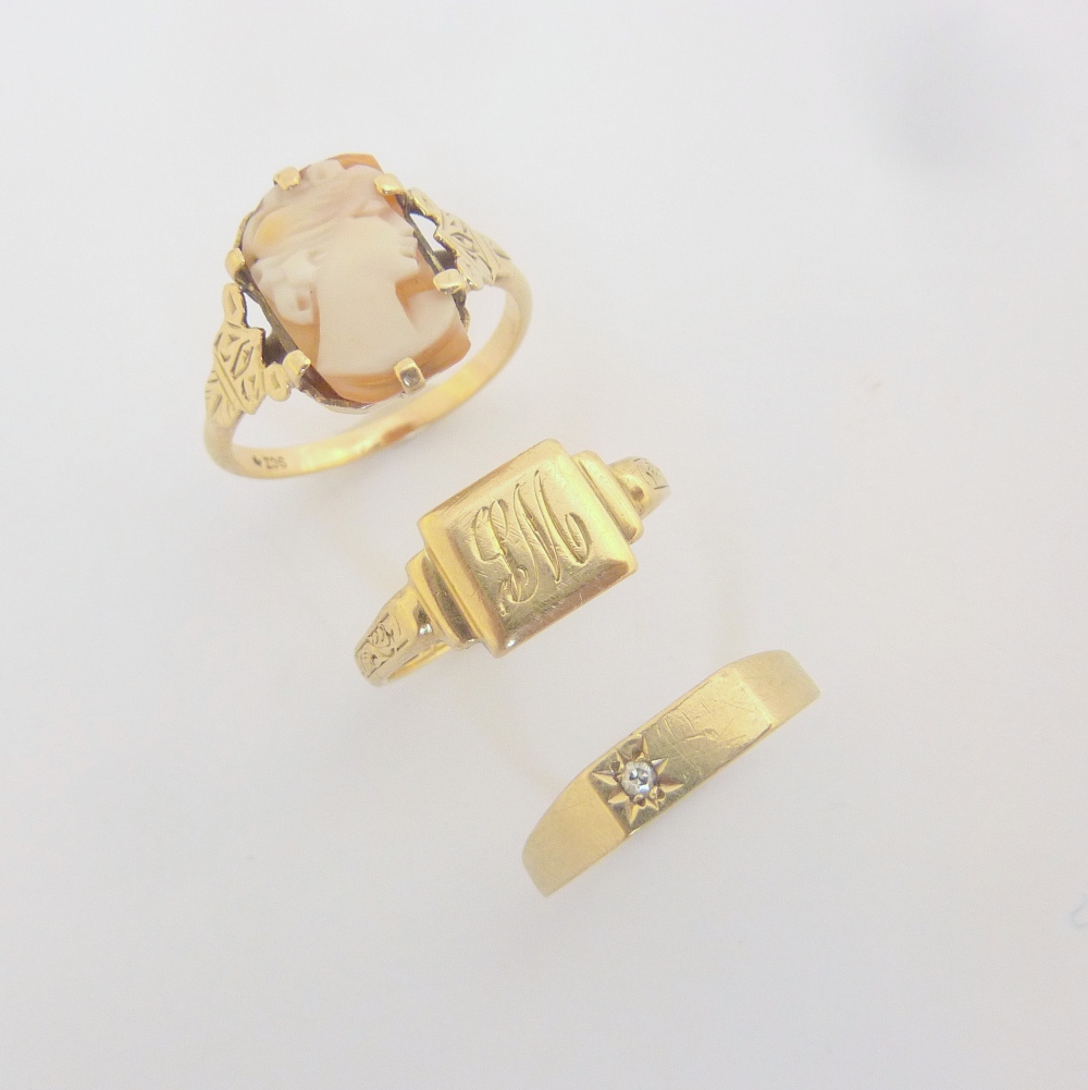 THREE 9CT GOLD RINGS, to include a cameo ring, a diamond ring and a monogrammed engraved ring, all