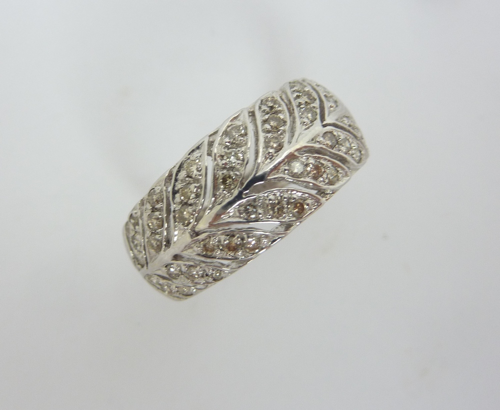 A 9CT GOLD DIAMOND RING, designed as a row of leaves with diamond accents, estimated diamond