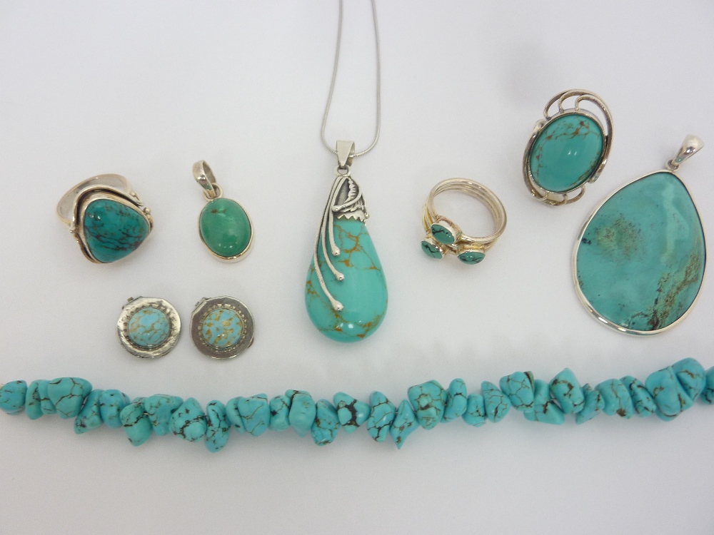 A SUITE OF TURQUOISE JEWELLERY, to include three rings, three pendants, a pair of earclips and a